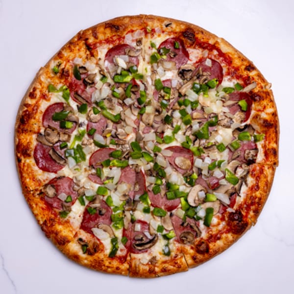 A whole Pizza Place pizza, topped with pepperoni, mushrooms, green peppers, and onions.