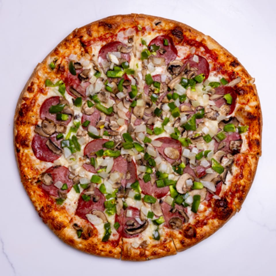 A whole Pizza Place pizza, topped with pepperoni, mushrooms, green peppers, and onions.